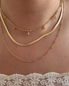 Yellow gold fill satellite chain necklace layered with mini serpentine necklace and mini spheres choker.