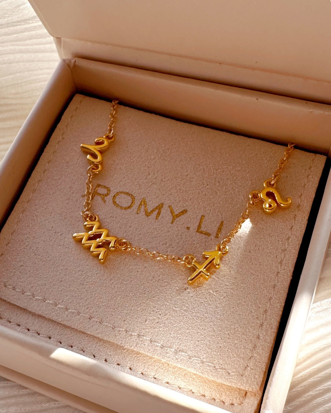 14k gold fill petite zodiac sign bracelet in a gift box.