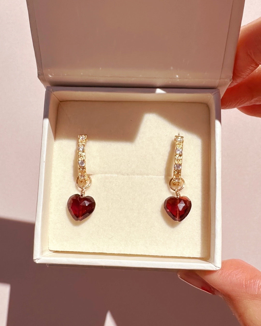 Close-up of a genuine garnet heart earring charm in 14k gold fill, approximately 9mm in size, designed for mix-and-match styling. Rich red gemstone symbolising love, passion, and protection, compatible with all hoops in the Mix and Match Earrings collection.