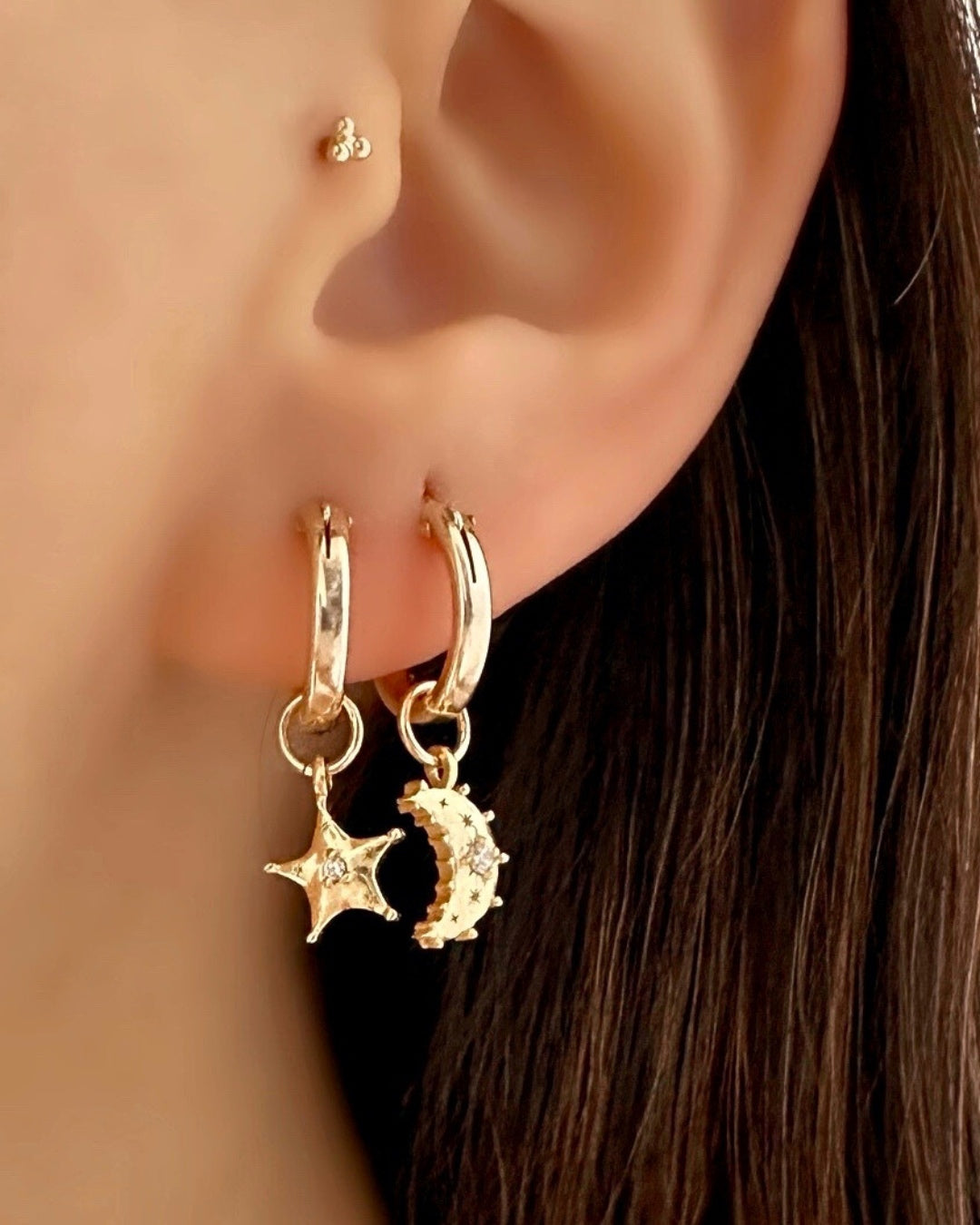 Close-up of the Nova star earring charm in 14k gold fill, approximately 7mm in size, designed to fit all hoops in the Mix and Match Earrings collection. Star design symbolising hope, guidance, and infinite possibilities.