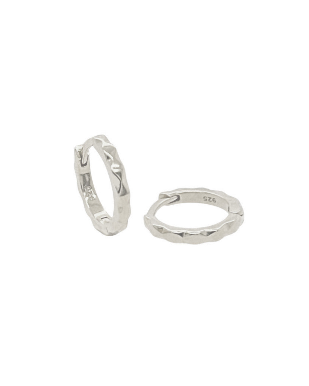 Sterling silver huggie hoop earrings with a hammered finish and no charms, displayed against a white background.