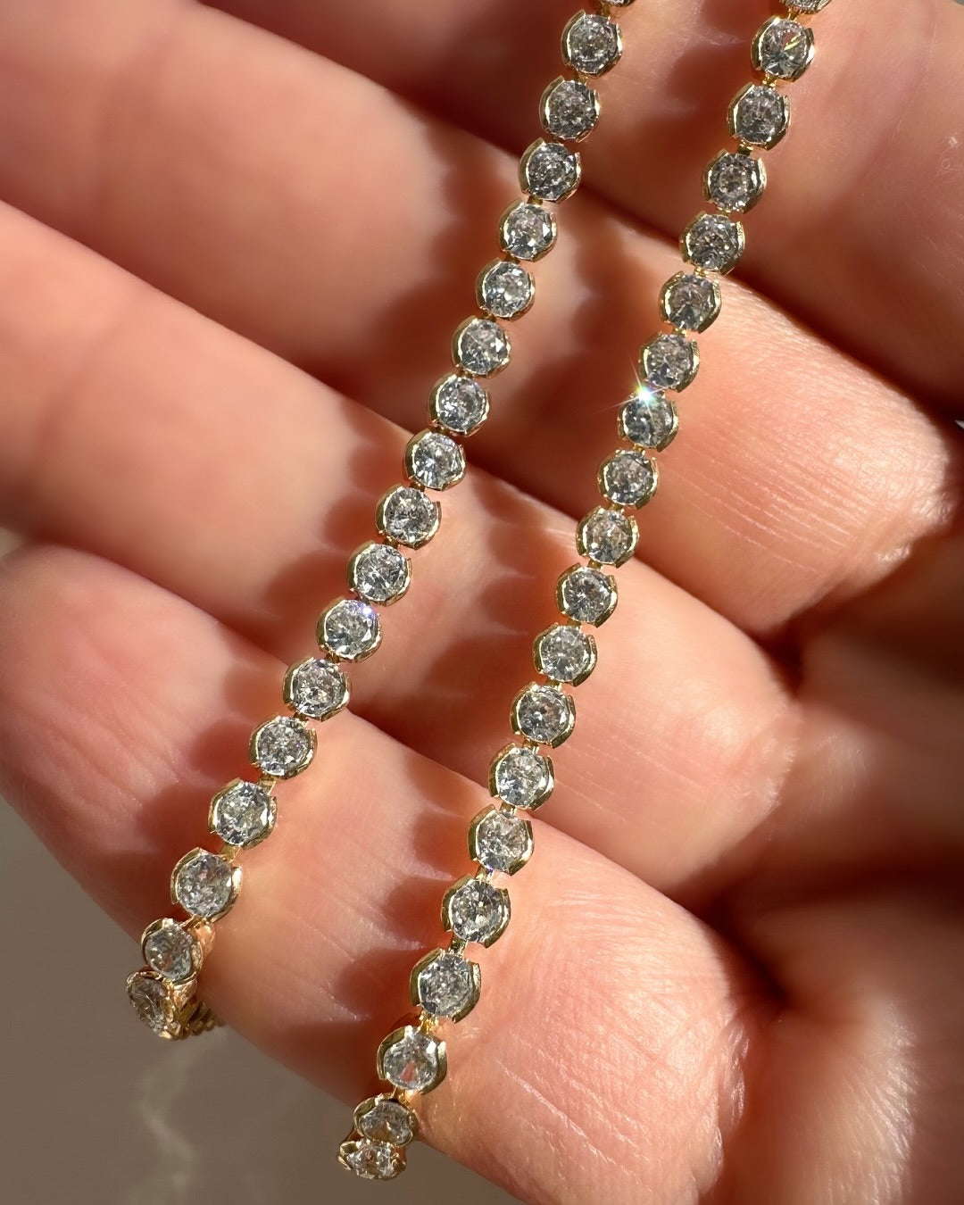 Close up of 2mm gold fill tennis choker necklace with bezel cubic zirconia crystals