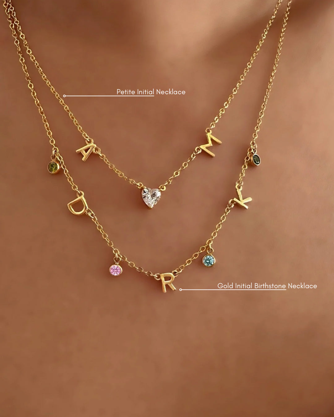 Gold Petite Initial Necklace with Letter A, Heart Gem, Letter M, layered with our Gold Initial Birthstone Necklace on a model