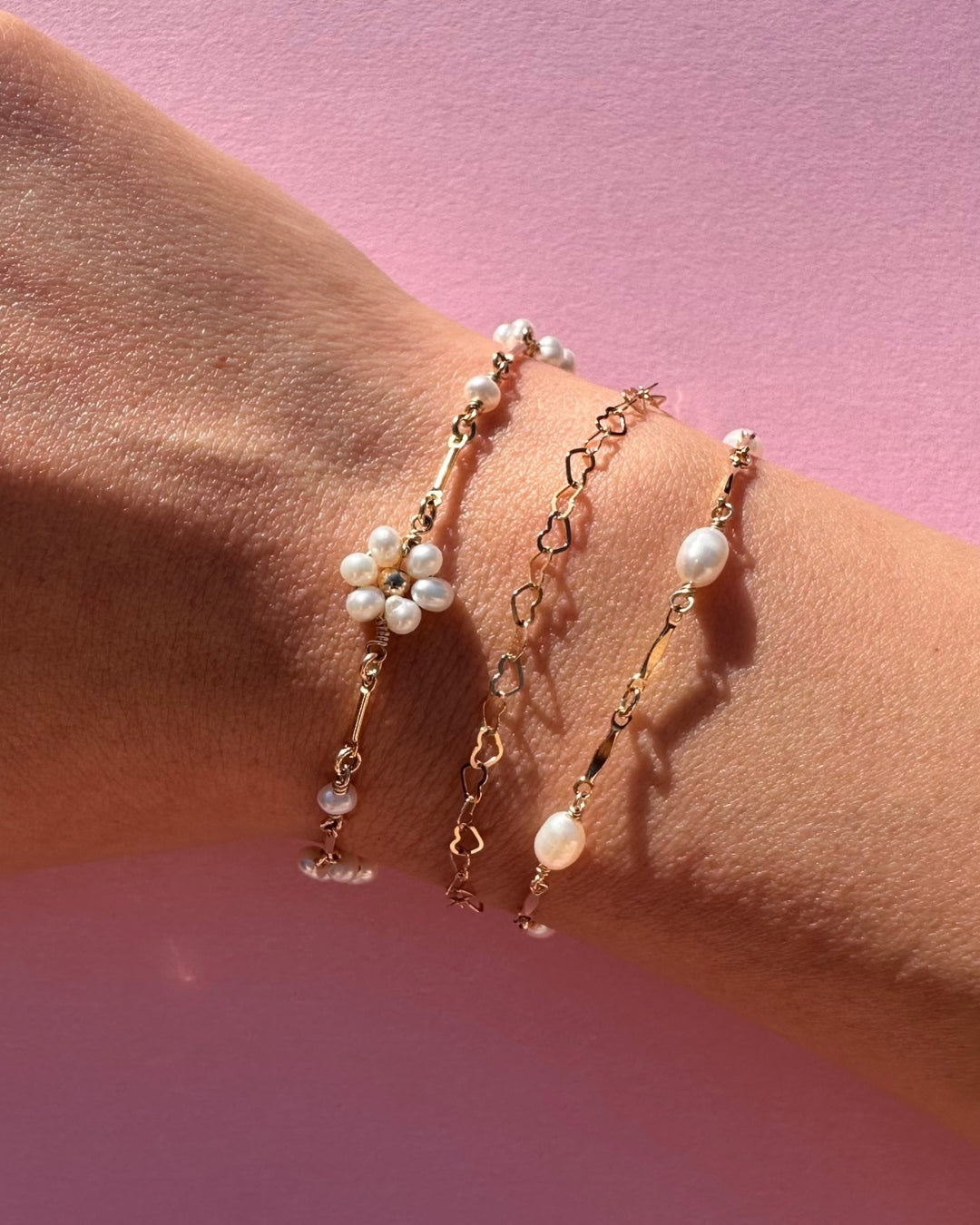 Model wearing Opalene Pearl Bracelet featuring gold-dapped bar links and pearls