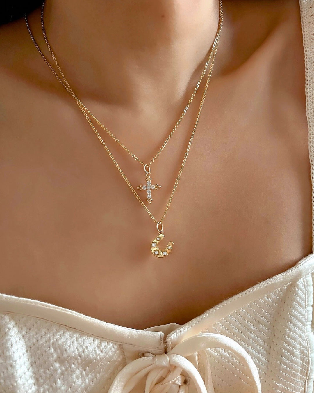 Gold fill evil eye horseshoe talisman protection pendant on a gold necklace cable chain on a model