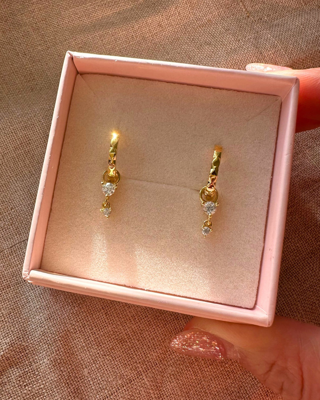 Gold vermeil hammered hoop earrings with removable crystal drop charms, photographed in a Romyli gift box.