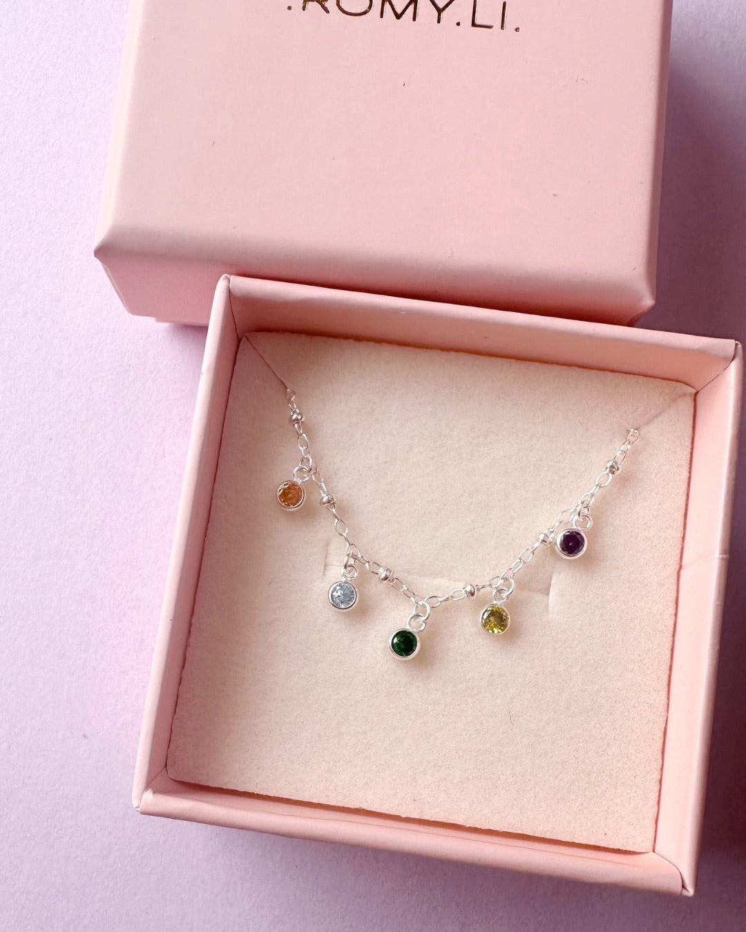 Customised Silver Petite Birthstone Necklace in a pink Romyli jewellery gift box.
