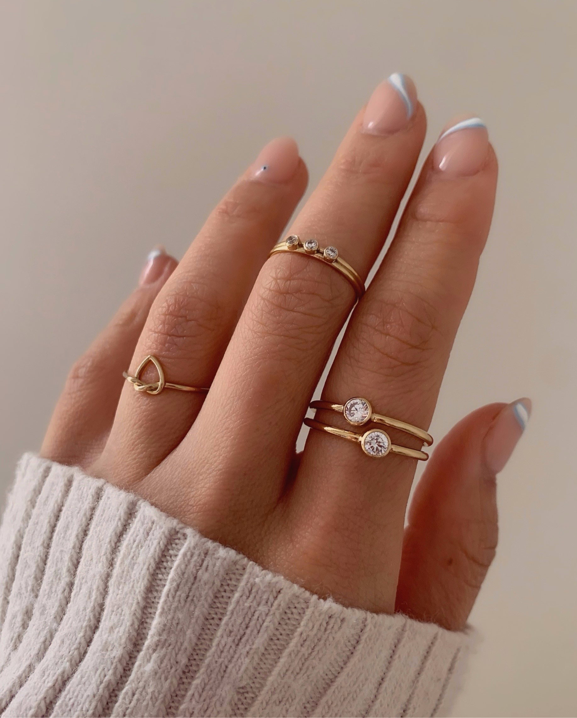 14k gold fill bezel framed solitaire cubic zirconia crystal stacking ring on a model.