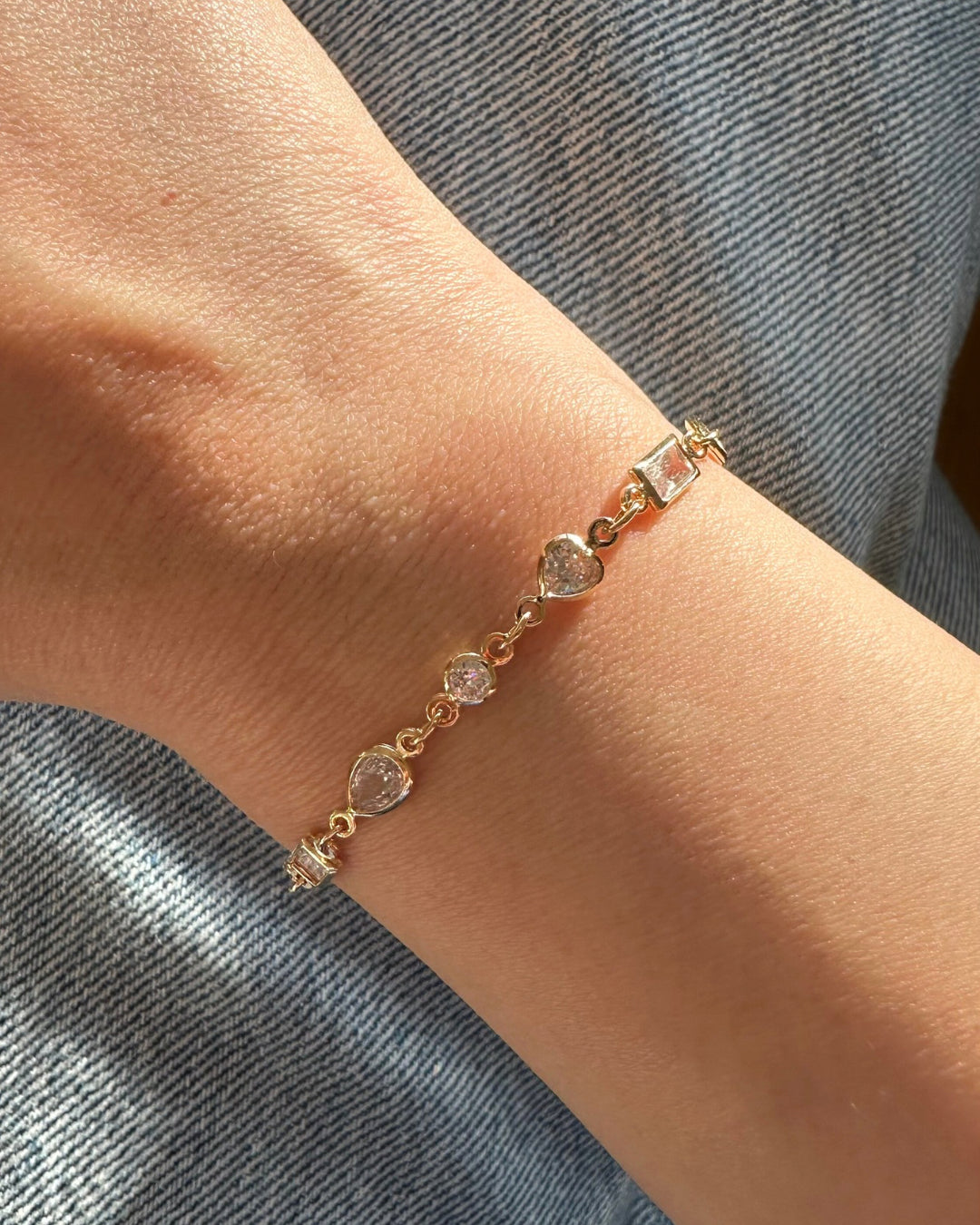14k gold fill bezel gem tennis bracelet with brilliant cut, heart, baguette cut and teardrop bezel. Made in Australia.