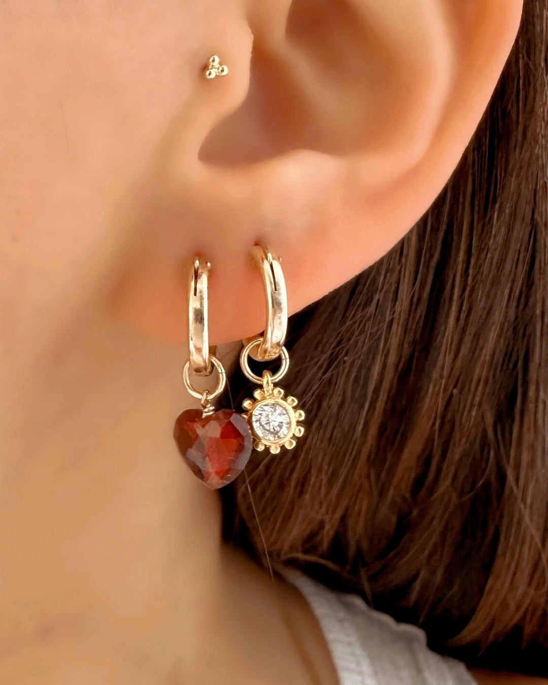 Close-up of a genuine garnet heart earring charm in 14k gold fill, approximately 9mm in size, designed for mix-and-match styling. Rich red gemstone symbolising love, passion, and protection, compatible with all hoops in the Mix and Match Earrings collection.