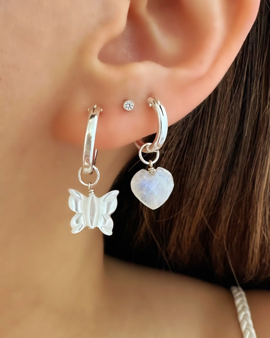 Close up of Sterling Silver Moonstone Heart Earring Charm, compatible with our hoops from our Silver Mix and Match Earrings collection.