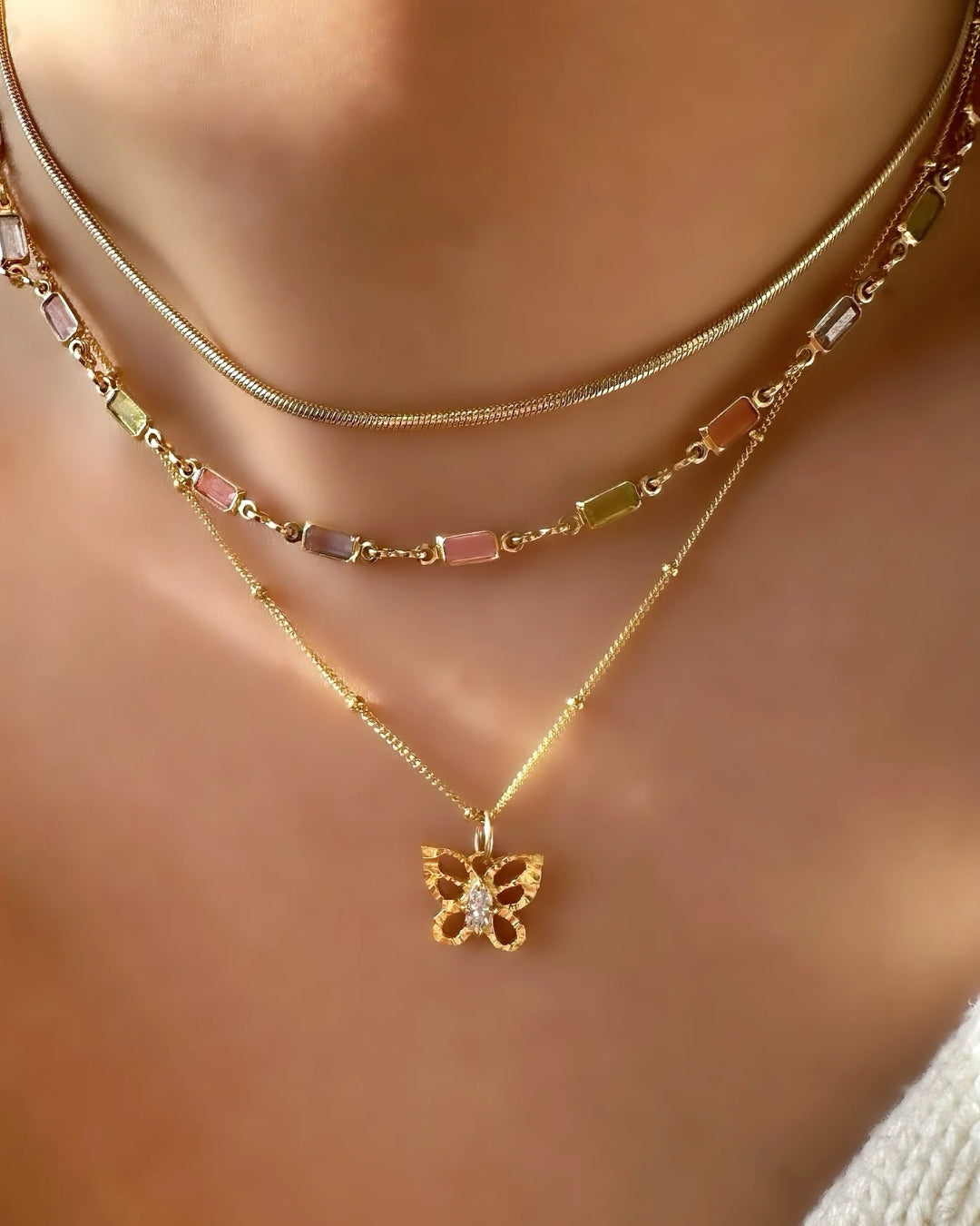 14k gold fill textured butterfly talisman pendant on a model