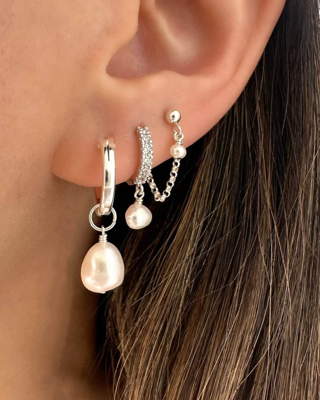 Model wearing silver 15mm hoop earrings with removable 10mm baroque freshwater pearl charms – versatile sterling silver Moondrop Pearl Hoops.