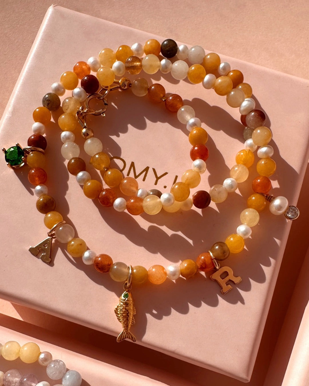 Golden Jade Charm Necklace on a Romyli jewellery gift box