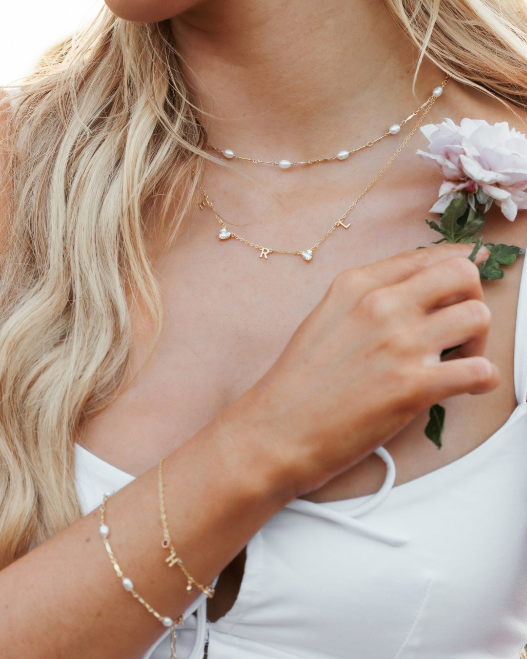 Model wearing Opalene Pearl Bracelet featuring gold-dapped bar links and pearls