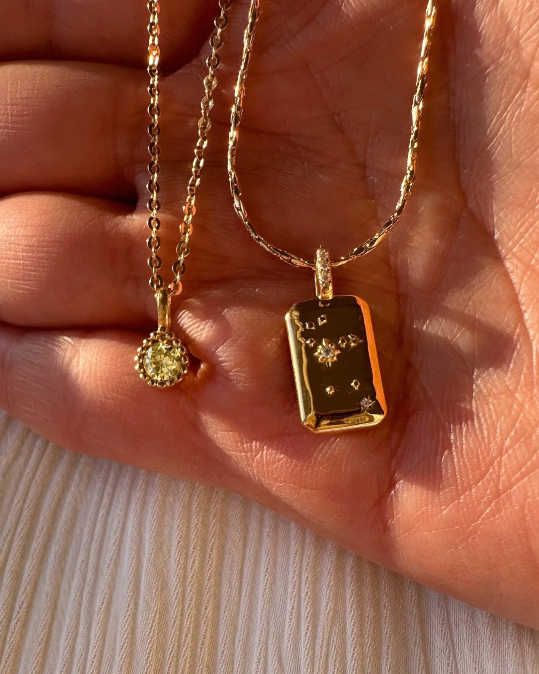 Flatlay of Leo Constellation Necklace and August Birthstone Necklace (Peridot)
