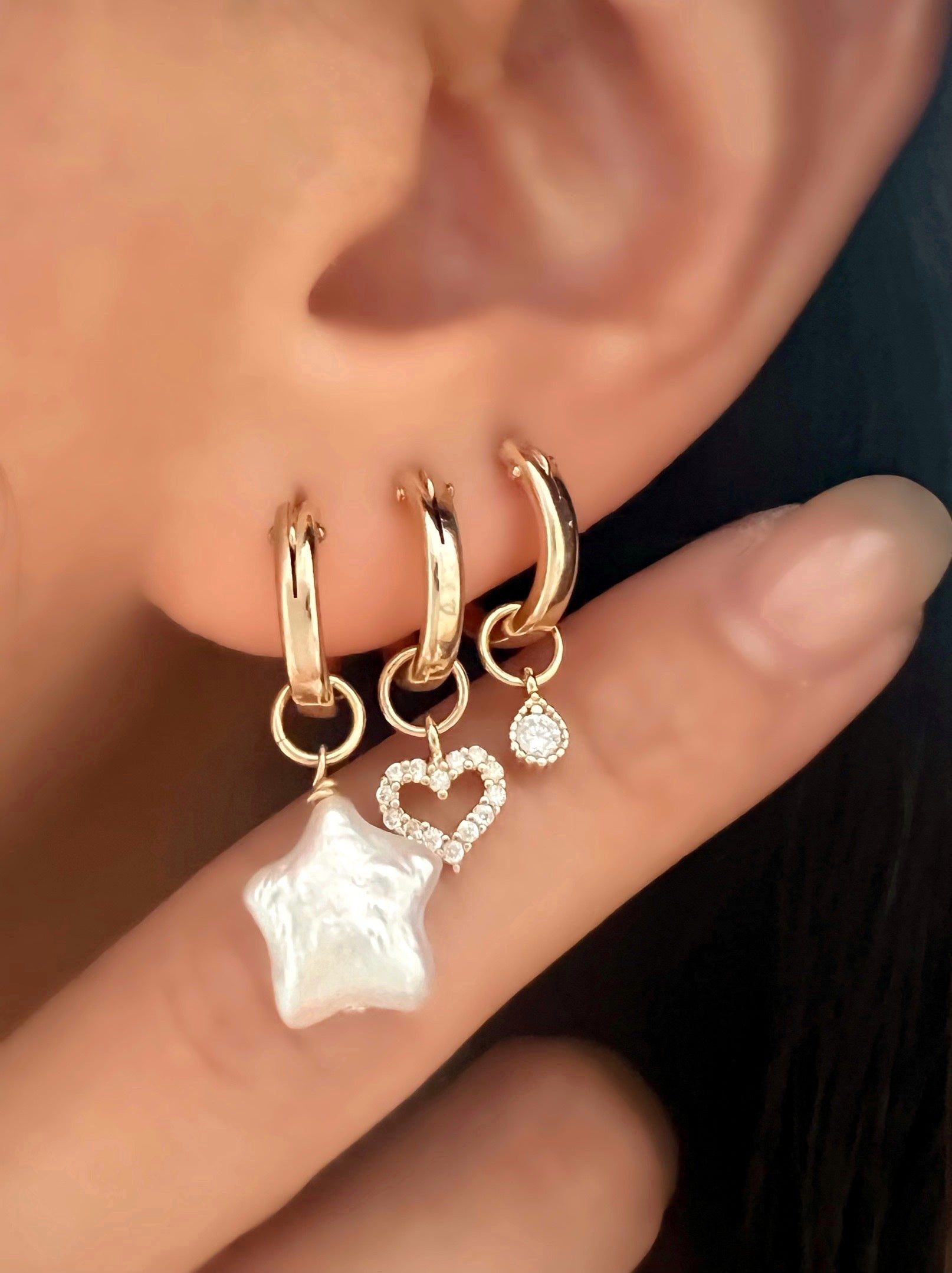 Gold freshwater Star Pearl hoop earring charm with a 14k gold fill hoops on a model