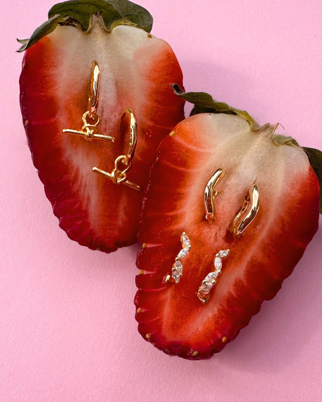 Gold sculptural huggie earrings with organic curved design. Flatlay of our Gold T-Bar Charm Huggies, Curvature Huggies and Fleck Marquise Huggies