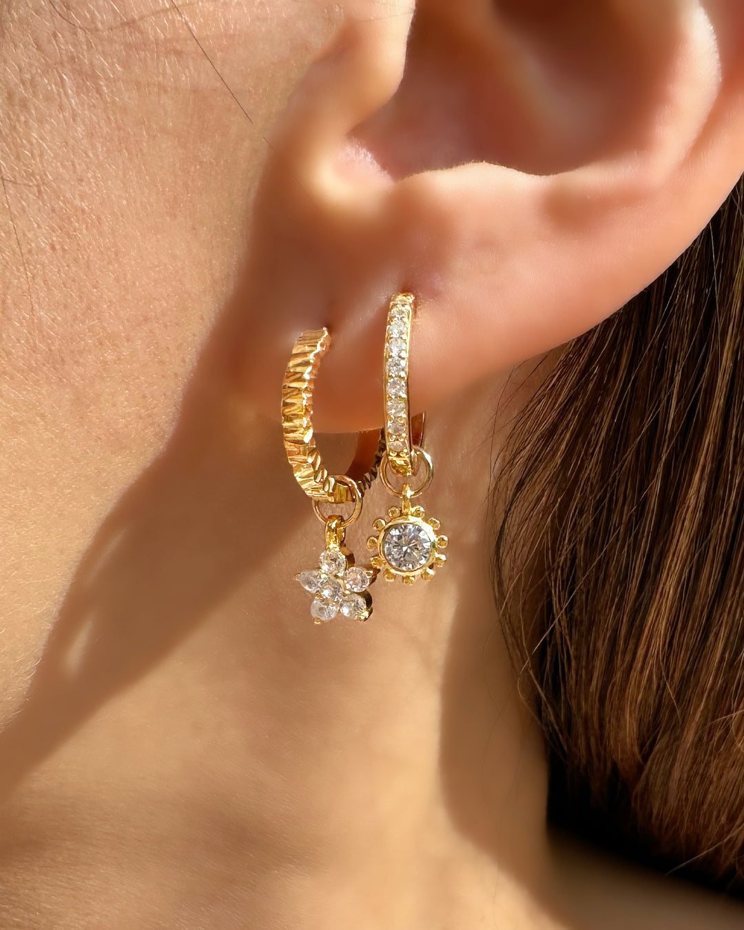 Close-up of the Sola sun earring charm in 14k gold fill, approximately 8mm in size, designed to fit all hoops in the Mix and Match Earrings collection. Sun design symbolising energy, vitality, and growth.