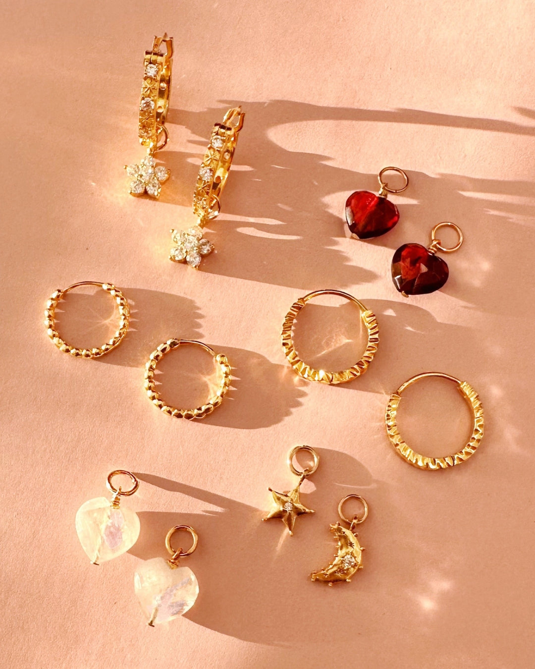 Close up of gold flora earring charm. Suitable for all Romyli hoops in our Mix and Match Earrings collection.