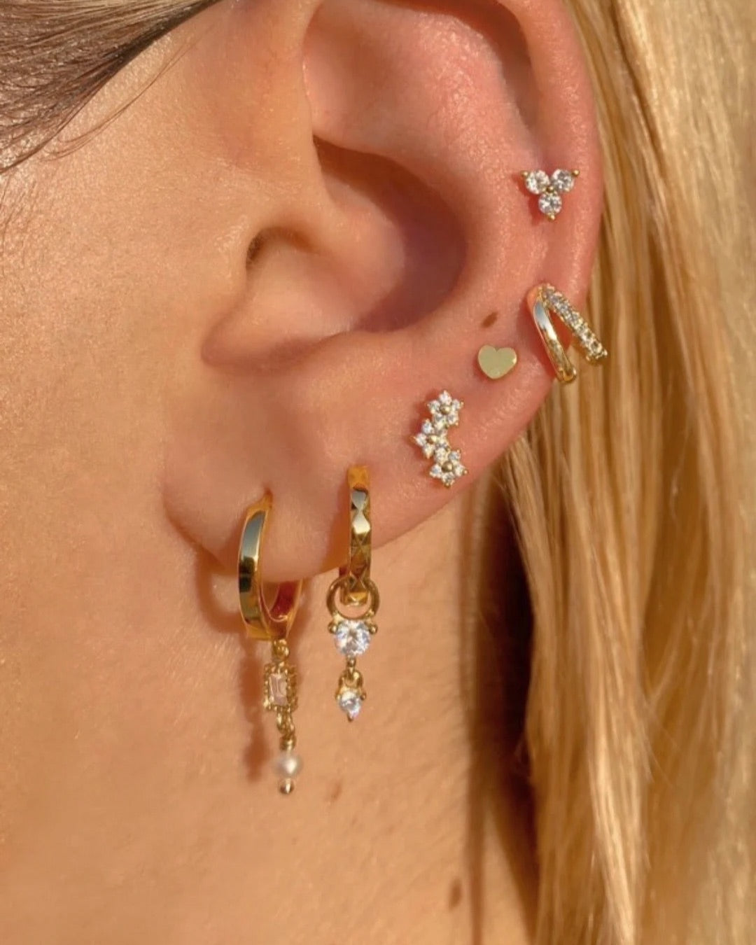 Gold Vermeil Huggies with Pave Crystal Charm details, photographed on a model