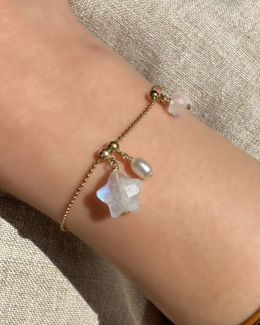 Model wearing 14k gold fill Moonstone Star Charm on the Charm Story Bead Bracelet