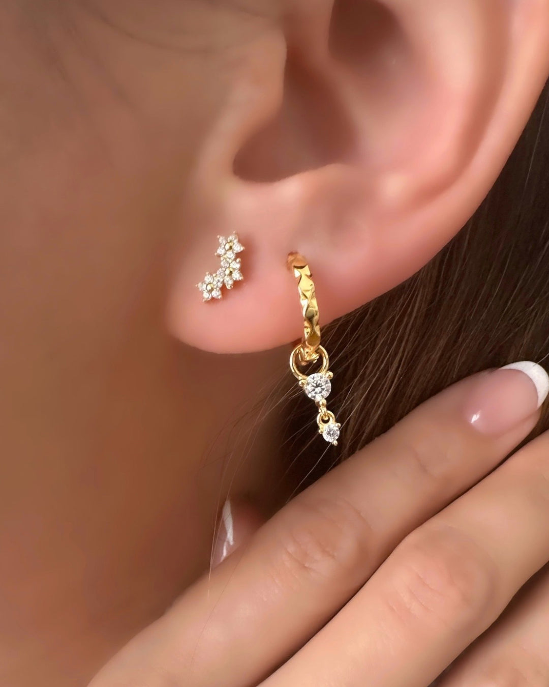 Gold Vermeil Huggies with Pave Crystal Charm details, photographed on a model