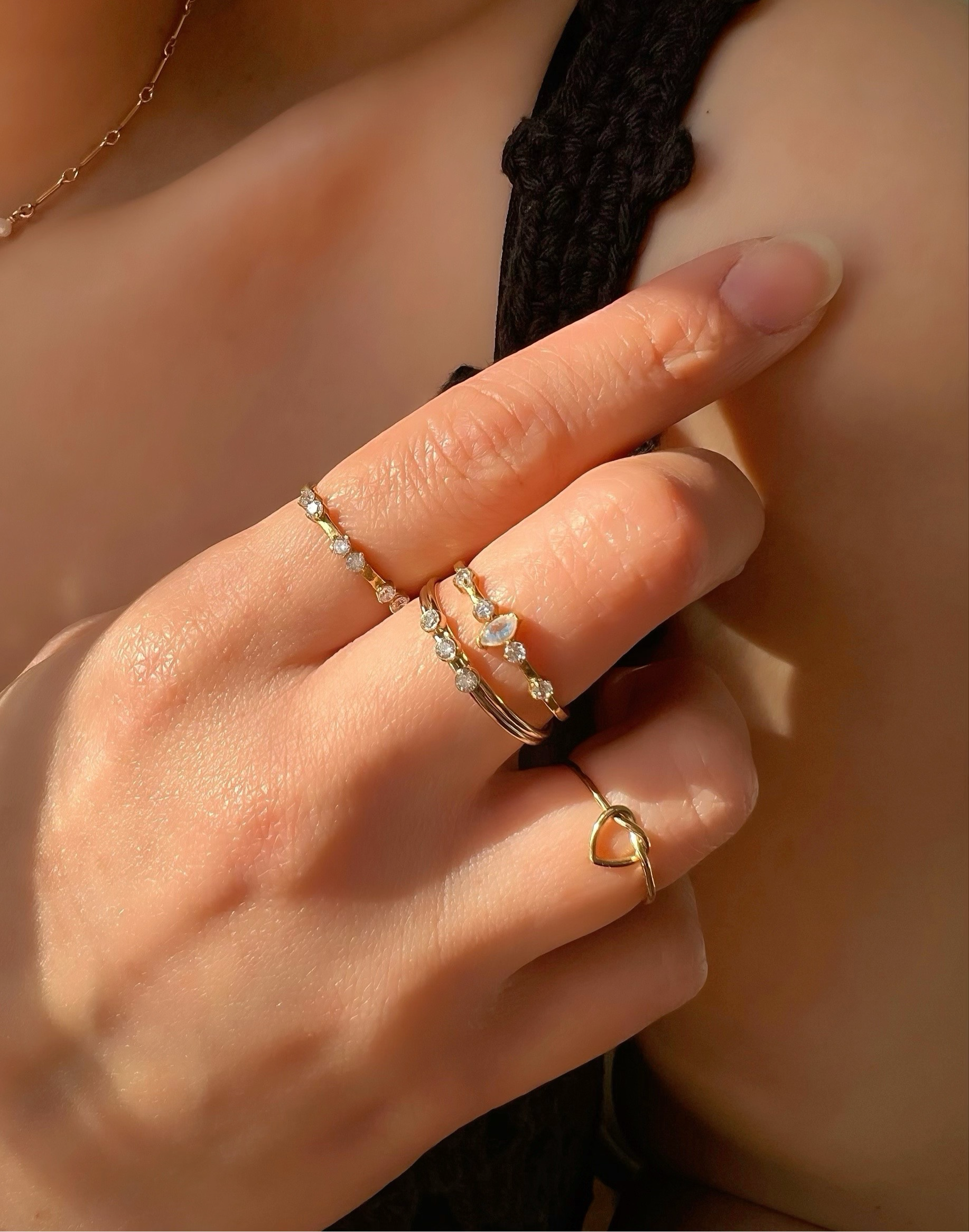 14k gold fill love heart knot stacking ring on a model.