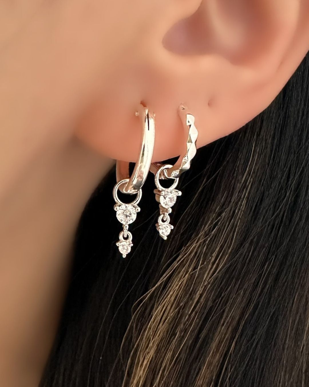Sterling silver crystal drop earring charm paired with the Silver Vela Hoops and Small Euro Hoops on a model.