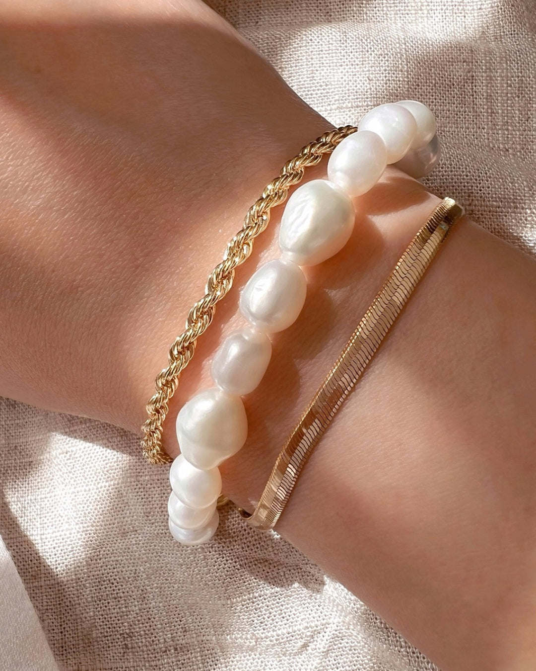 Australian-designed Baroque Pearl Bracelet featuring natural, irregular baroque pearls for a timeless, elegant look. Styled layered with our Gold Fill Rope Bracelet and Mini Serpentine Bracelet.