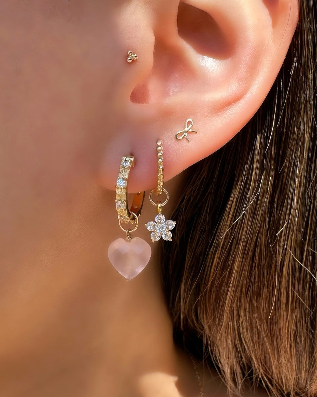 Close up of gold flora earring charm. Suitable for all Romyli hoops in our Mix and Match Earrings collection.