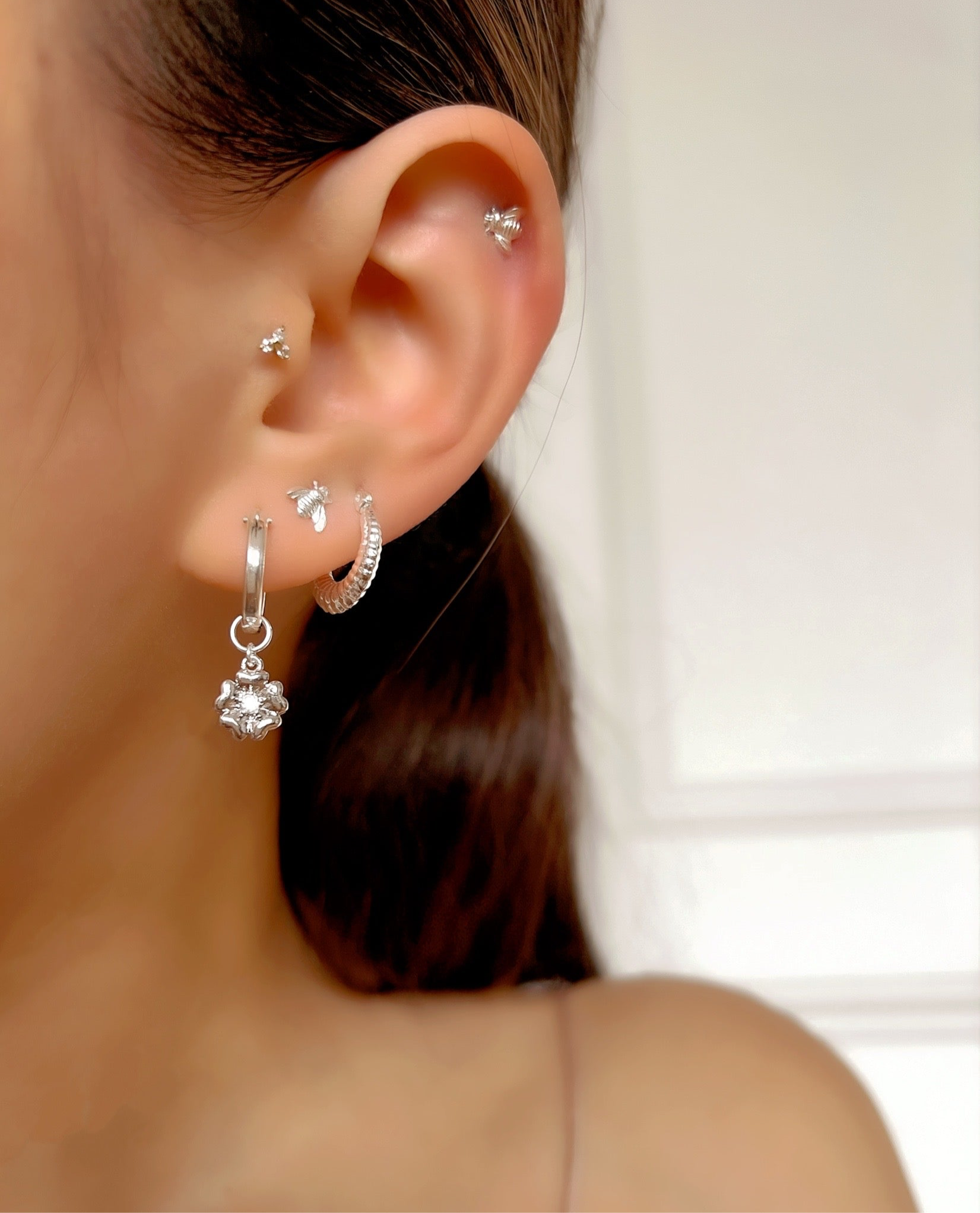 Sterling silver honey bee stud post earrings with butterfly backs on a model