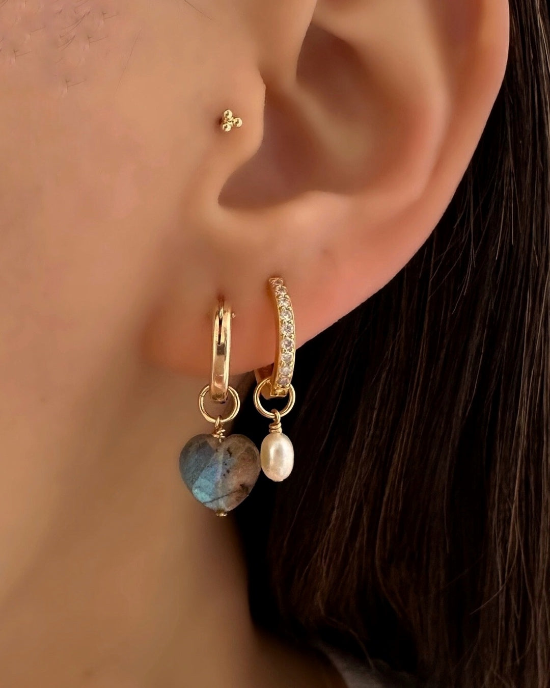 Close-up of a genuine labradorite heart earring charm in 14k gold fill, approximately 10mm in size, designed to fit all hoops in the Mix and Match Earrings collection. Iridescent gemstone symbolising intuition, transformation, and protection, associated with February and November and linked to Scorpio, Sagittarius, and Leo.