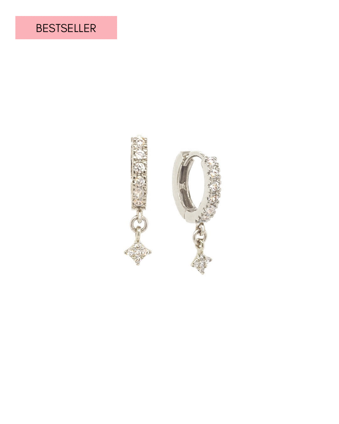 Sterling silver huggie earrings with pavé white crystals and dangling North Star charms, photographed on a white background.