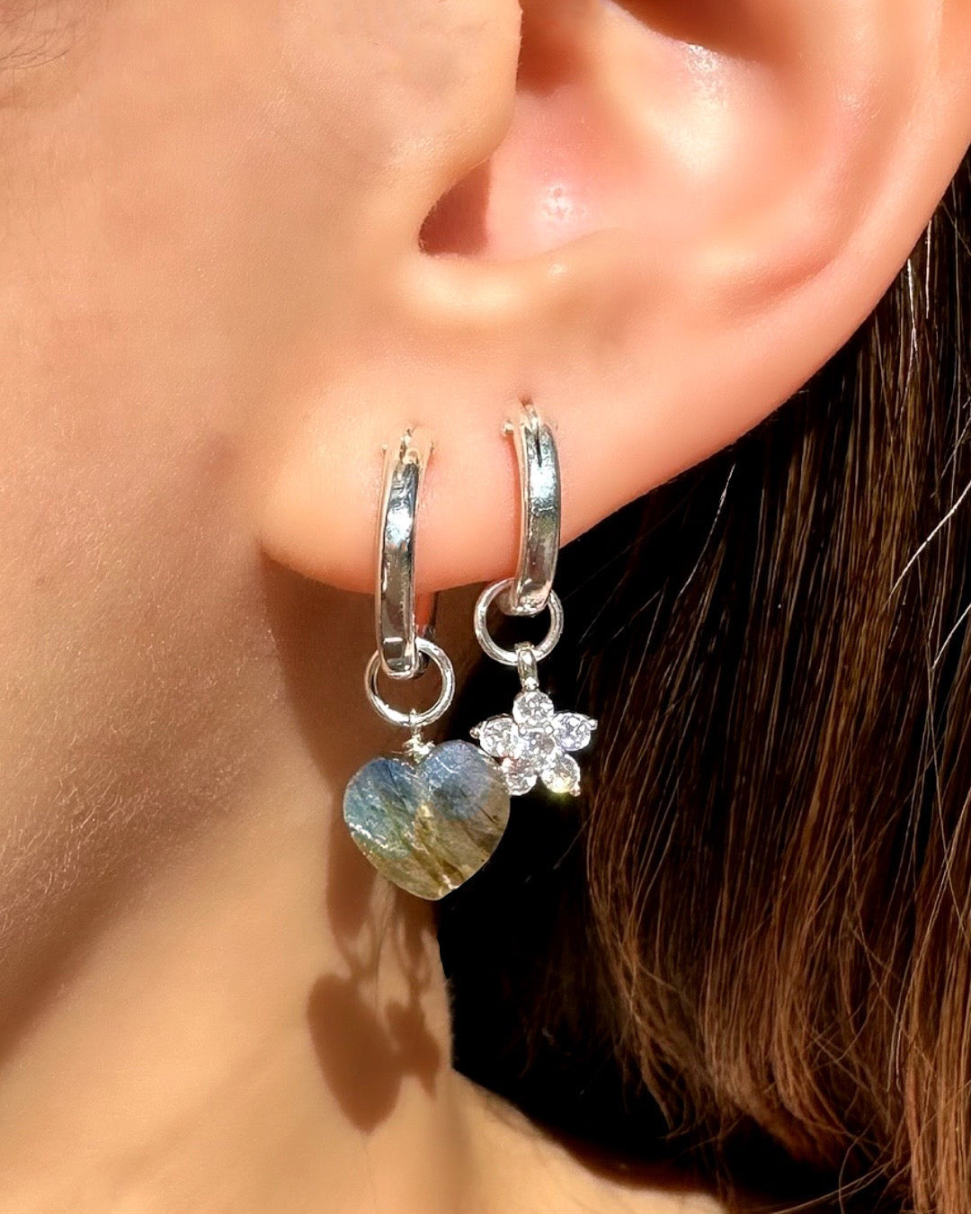 Model wearing Sterling silver Mini Euro Hoops paired with Labradorite Heart Charm and Flora Earring charm