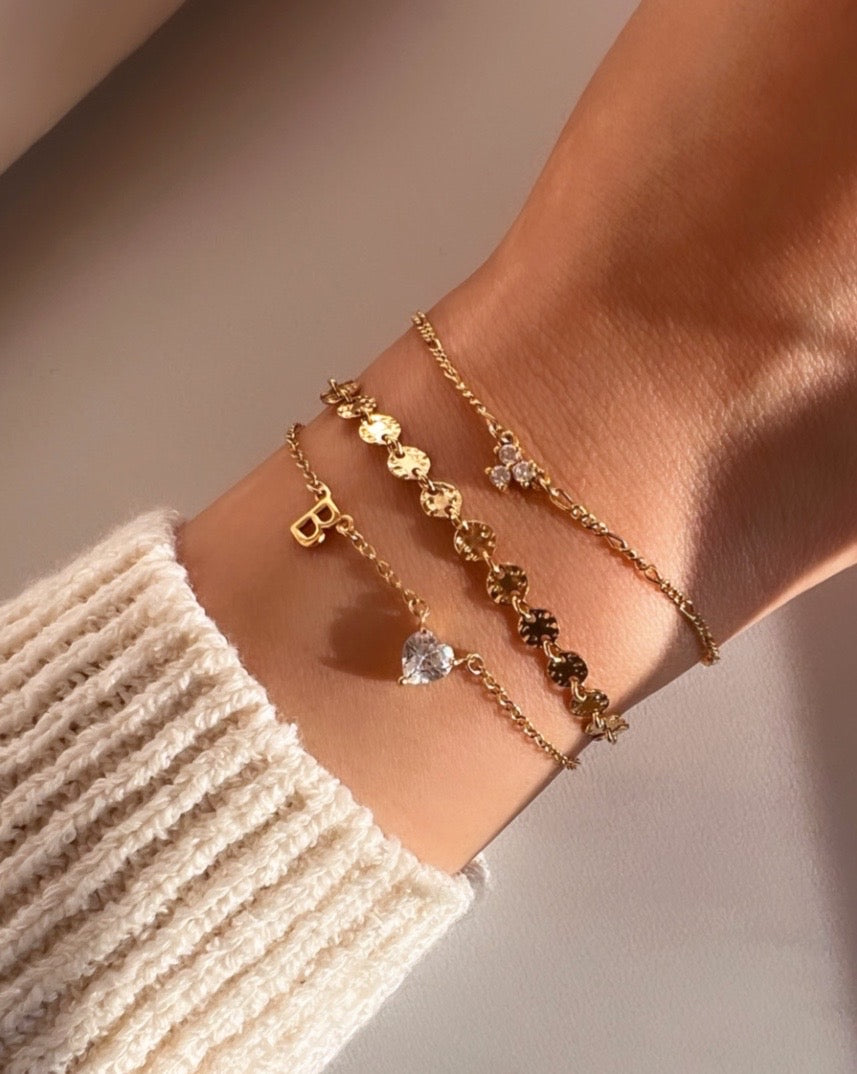 Customizable petite initial bracelet with the option to add up to 5 letters, gems or heart