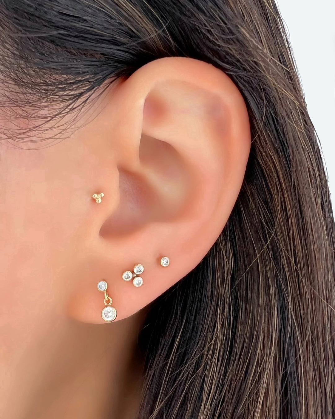 14k yellow gold fill trio trinity bezel stud earrings on a model