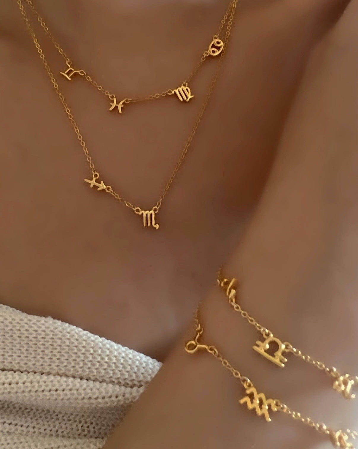 Customise small gold zodiac necklaces and bracelets on a model 