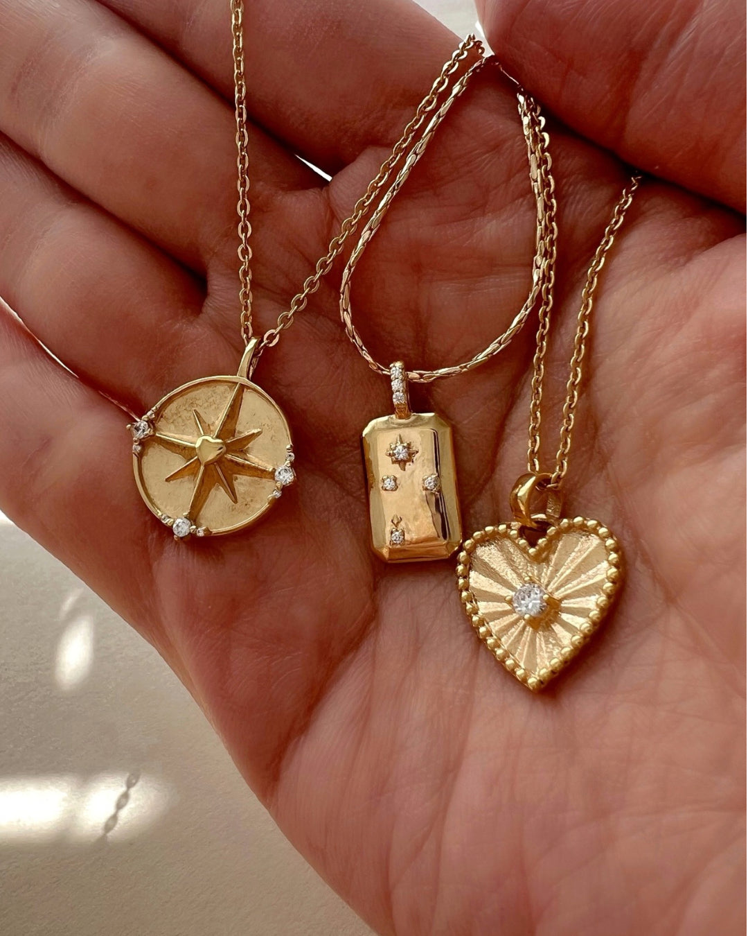 Gold filled yellow gold necklace chain with heart token pendant and dreamers pendant. 
