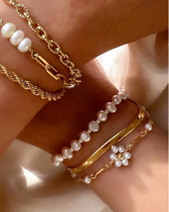 Gold Daisy Pearl Bracelet stacked with gold and pearl bracelets 