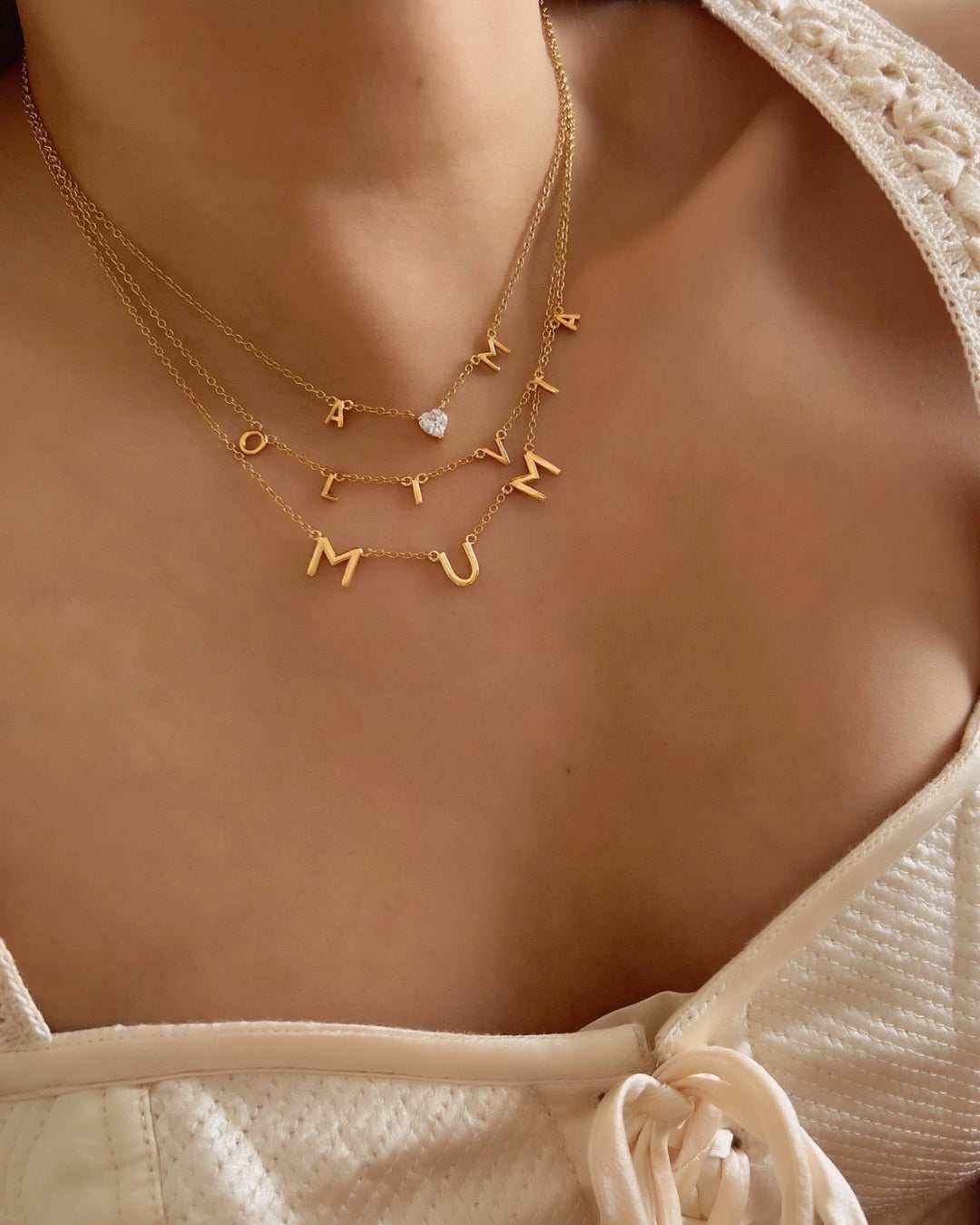 Gold Petite Initial Necklaces and Initial Necklace on a model 