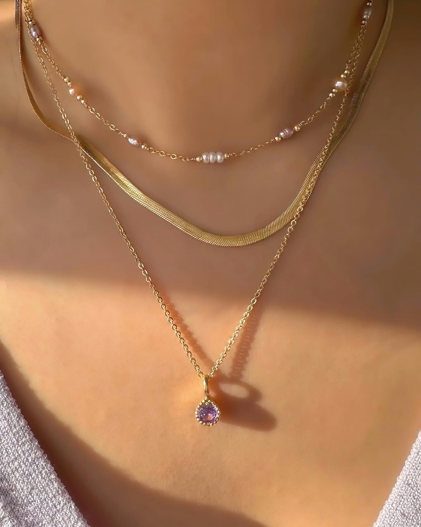 Cloudchaser Pearl Choker layered with the Gold Mini Serpentine Necklace and June Birthstone Necklace