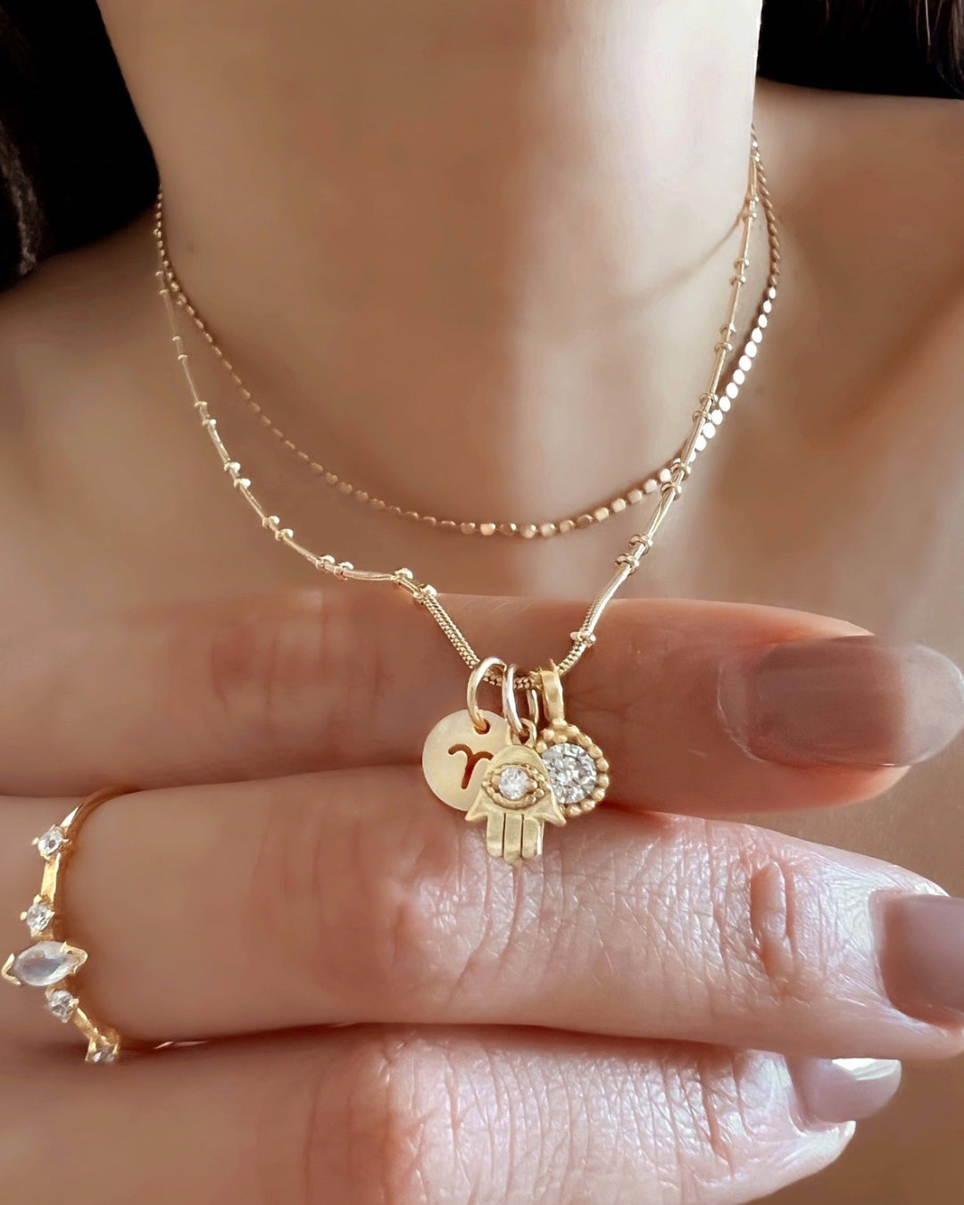 Gold Petite Hamsa evil eye Talisman Pendant with Gold Beaded Necklace Chain on a model