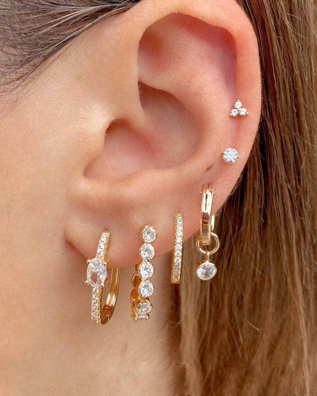 Gold Pave Hoops with cubic zirconia crystals on a model