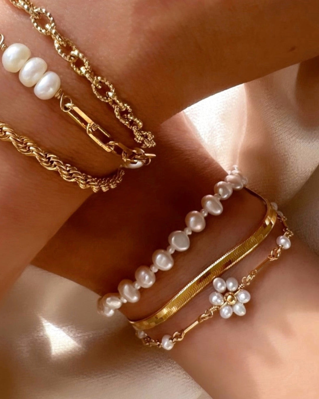 Gold Daisy Pearl Bracelet stacked with gold and pearl bracelets