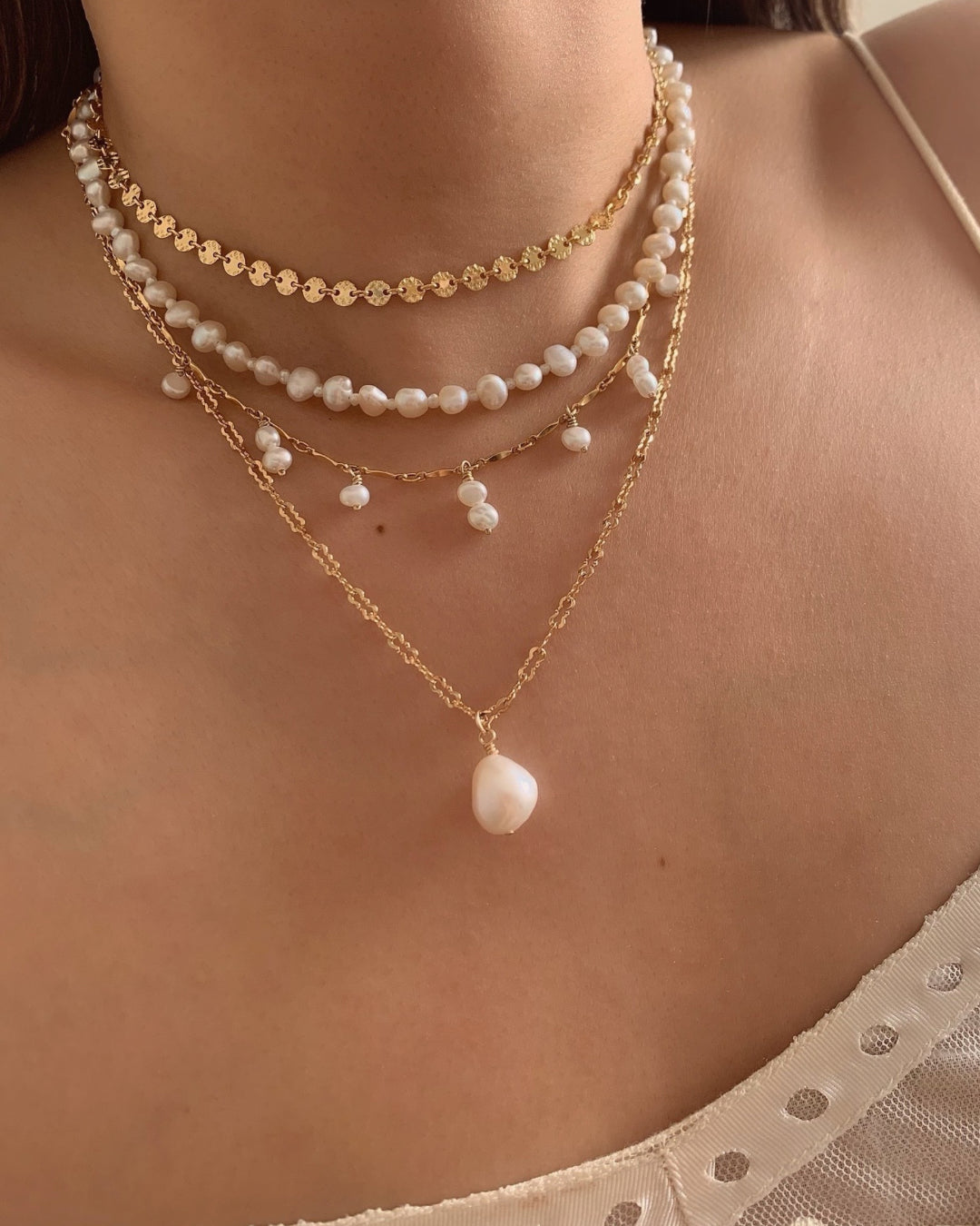 Gold freshwater pearl pendant on gold fill necklace chain on a model