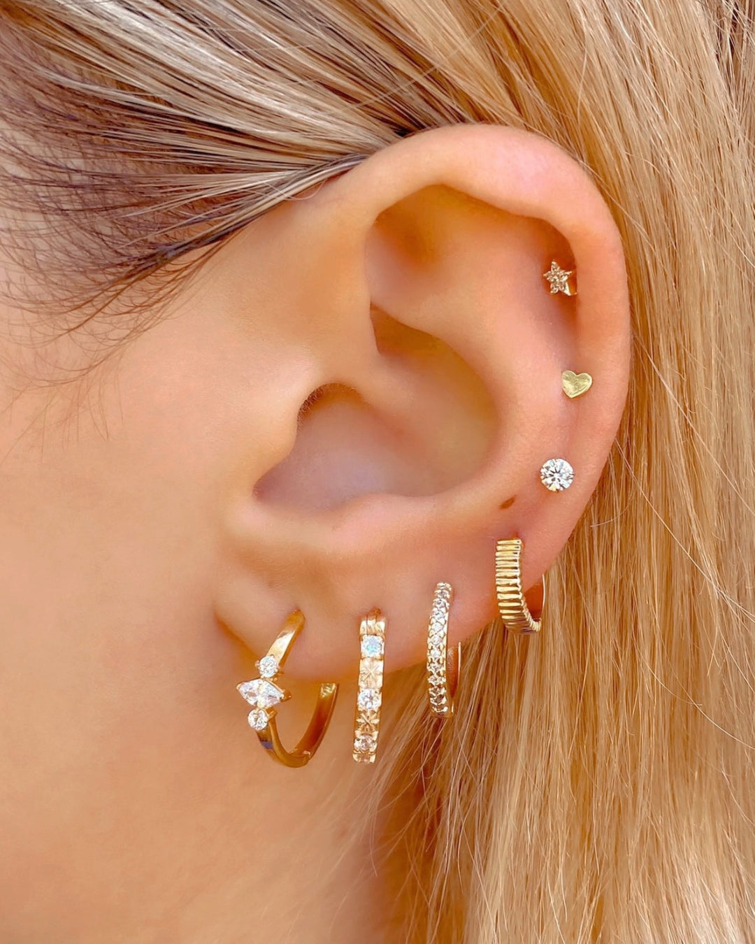 Gold fill white crystal star hoops earrings on a model