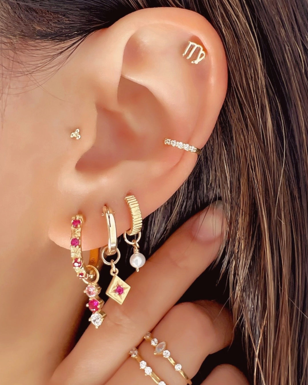 Gold Fill Ruby Red North Star Hoops Earrings on a model
