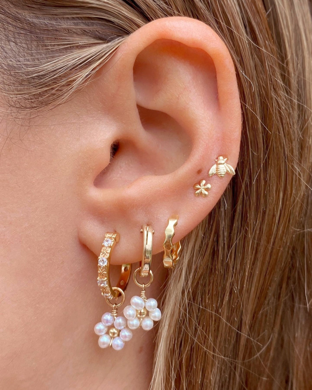 Gold fill white crystal star hoops earrings with freshwater daisy pearl earring charms on a model