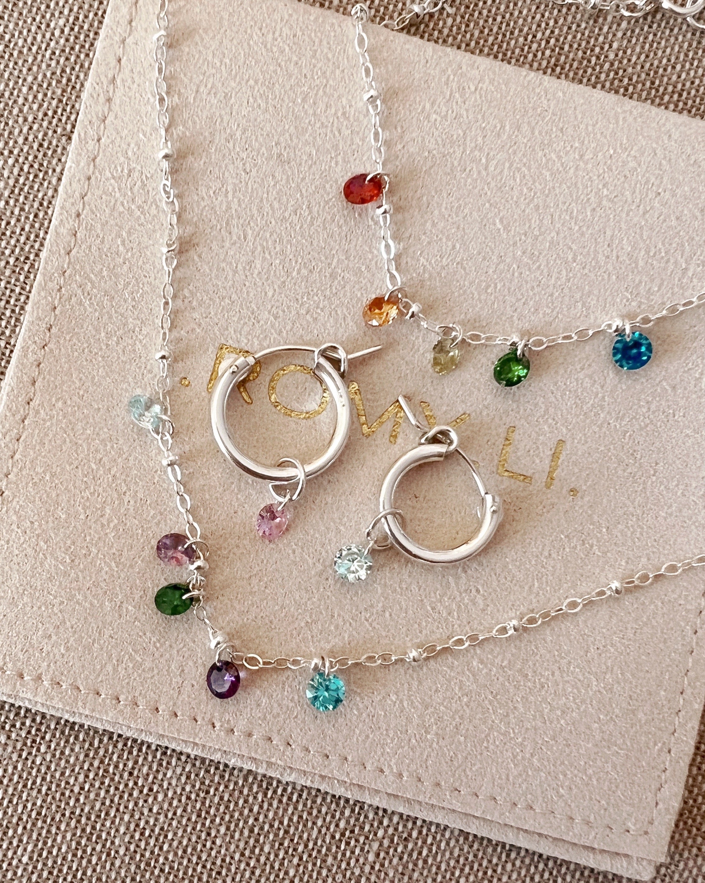 Sterling Silver Huggie Hoops Earrings with Petite birthstone earring charms. Made in Australia.